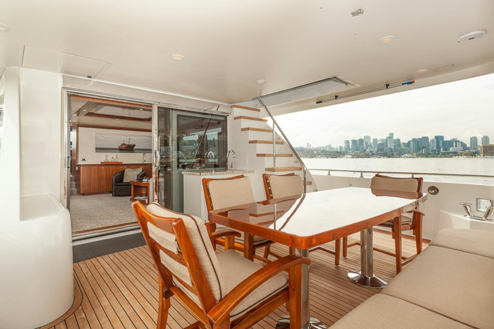 a room with a table chairs and a window aboard JEANNE SEA QUA Yacht for Sale