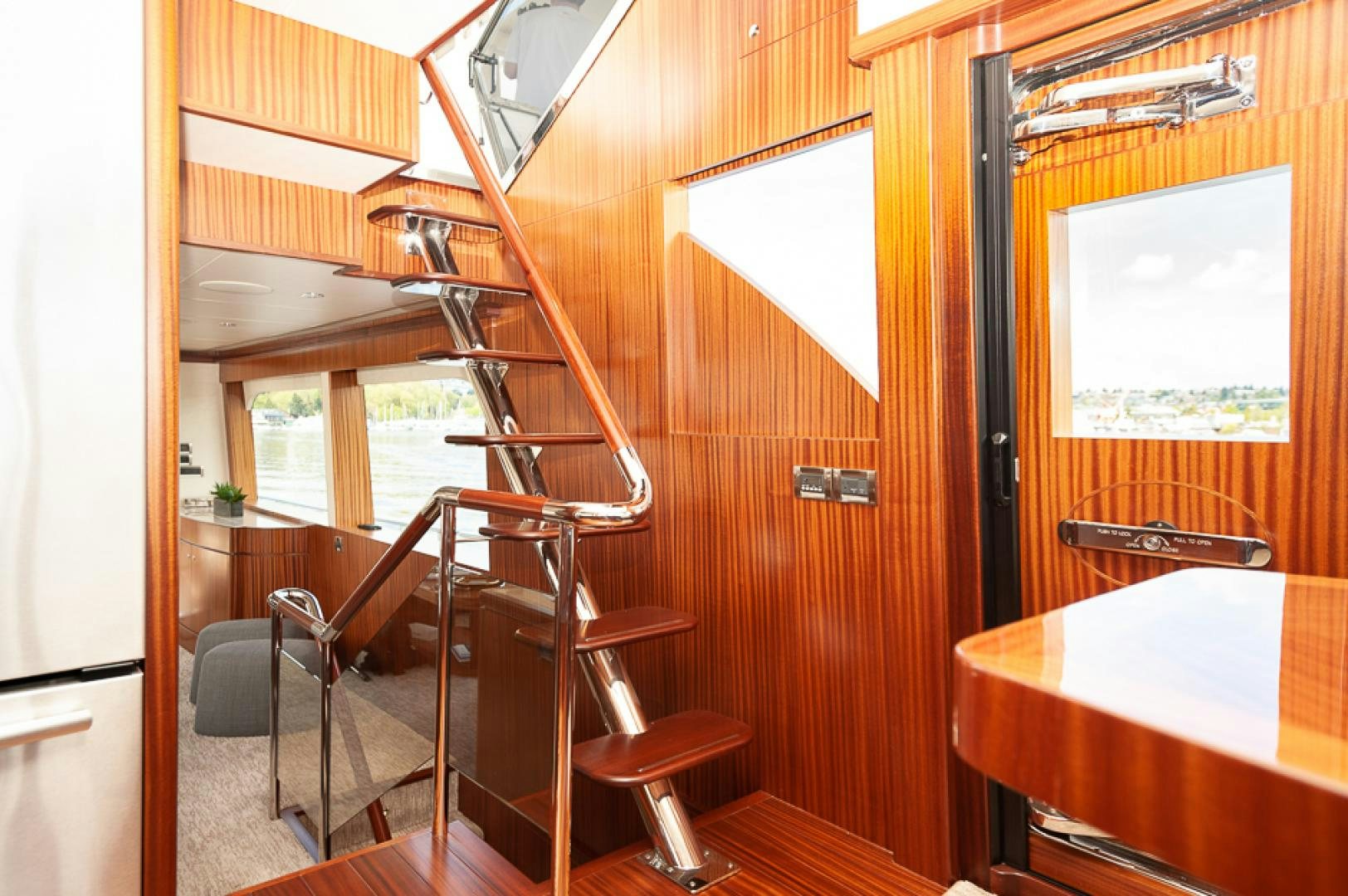 a wooden staircase with a table and chairs aboard JEANNE SEA QUA Yacht for Sale