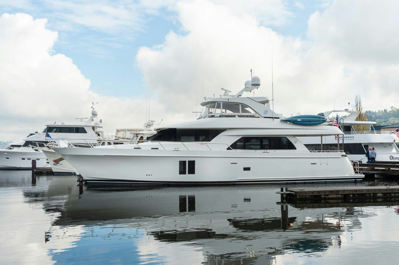 a white yacht docked at a dock aboard JEANNE SEA QUA Yacht for Sale