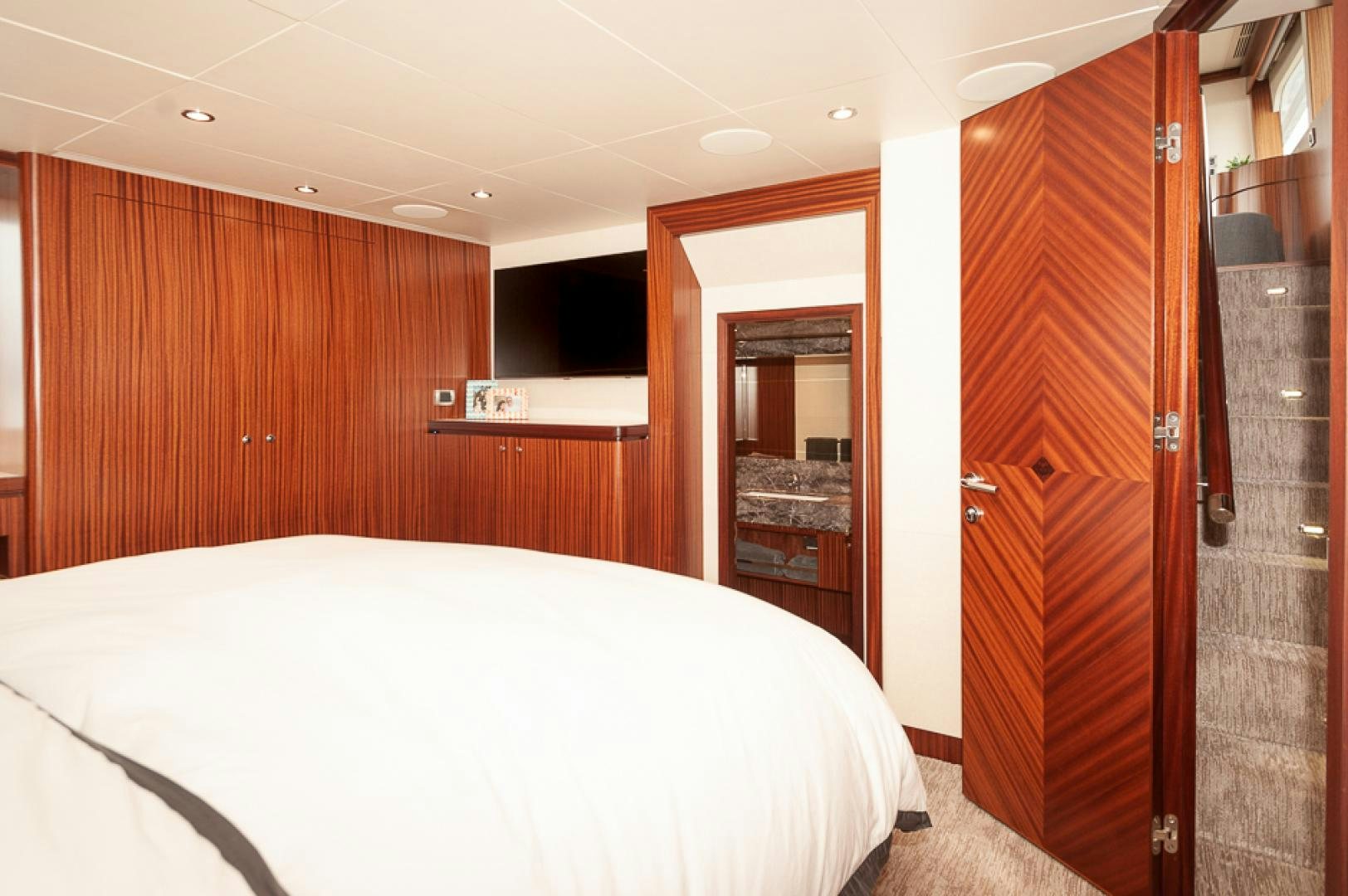 a bedroom with a bed and a closet aboard JEANNE SEA QUA Yacht for Sale
