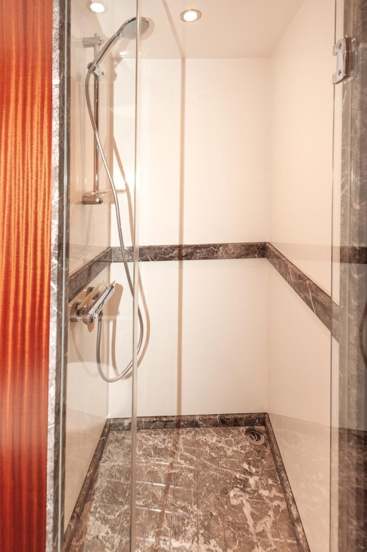 a shower with a tile floor aboard JEANNE SEA QUA Yacht for Sale