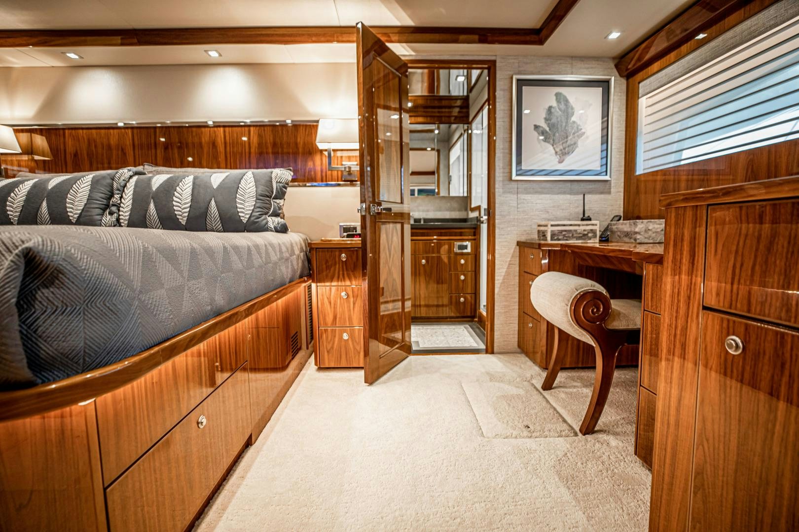 a bedroom with a bed and a desk aboard INDIGO Yacht for Sale