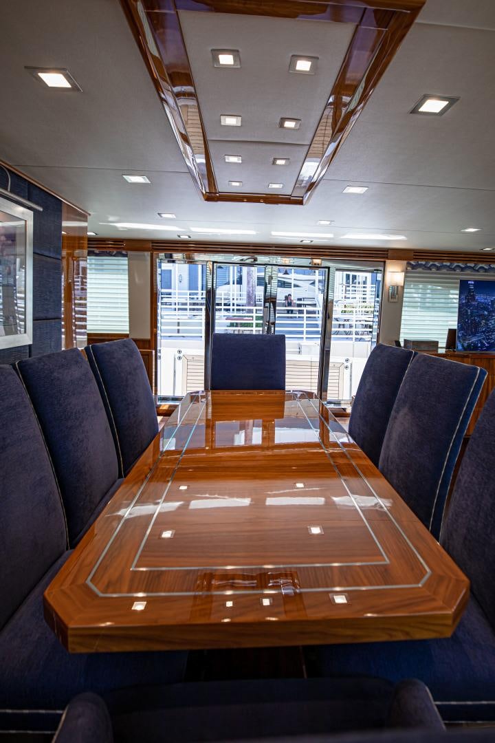 a large table with chairs around it aboard INDIGO Yacht for Sale