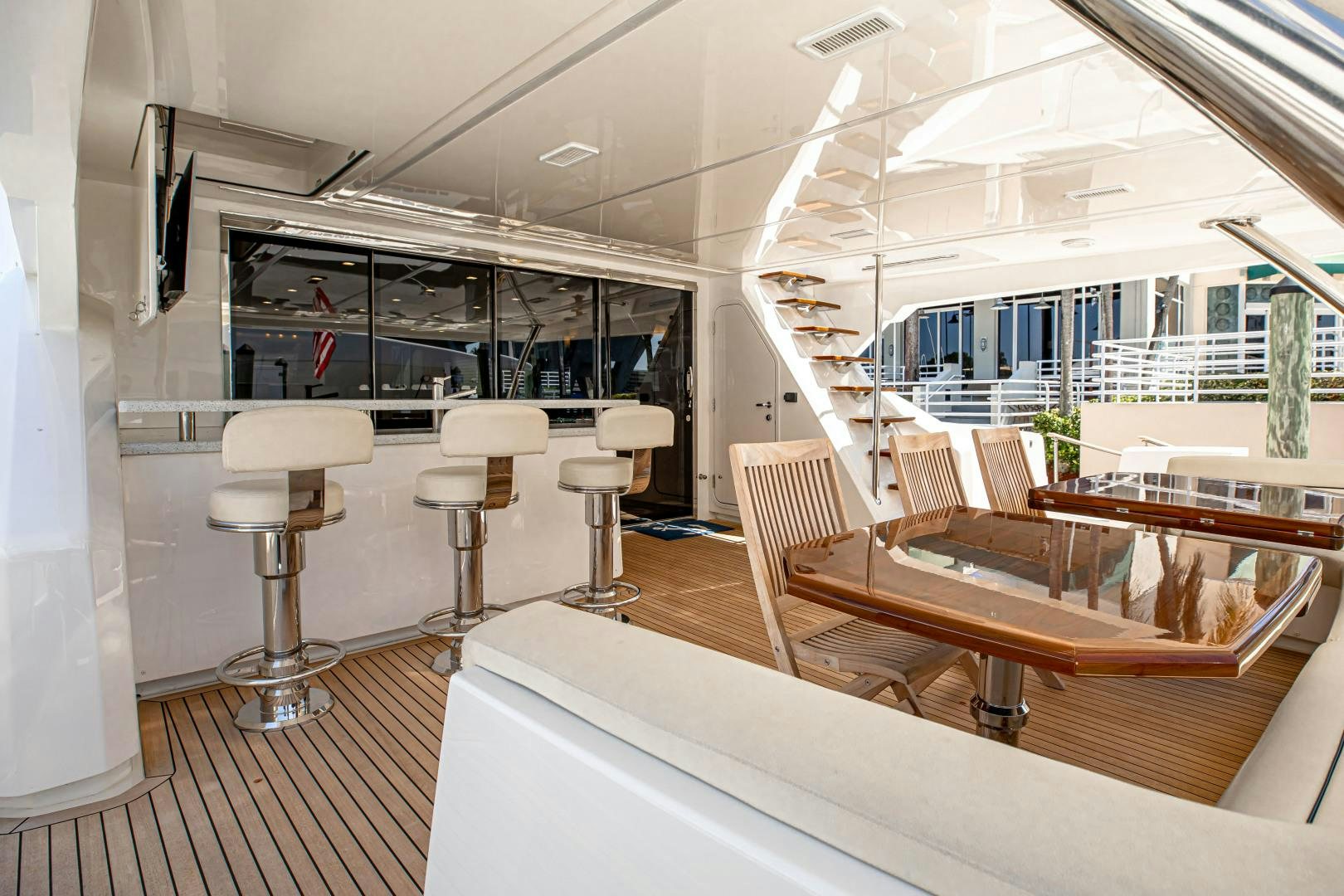 a room with tables and chairs aboard INDIGO Yacht for Sale