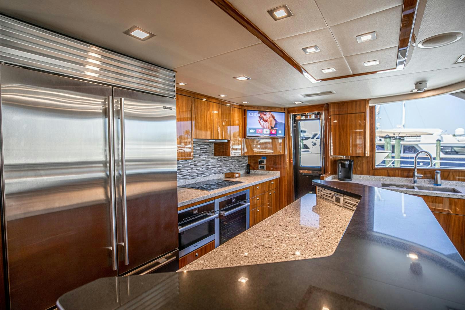 a large kitchen with stainless steel appliances aboard INDIGO Yacht for Sale