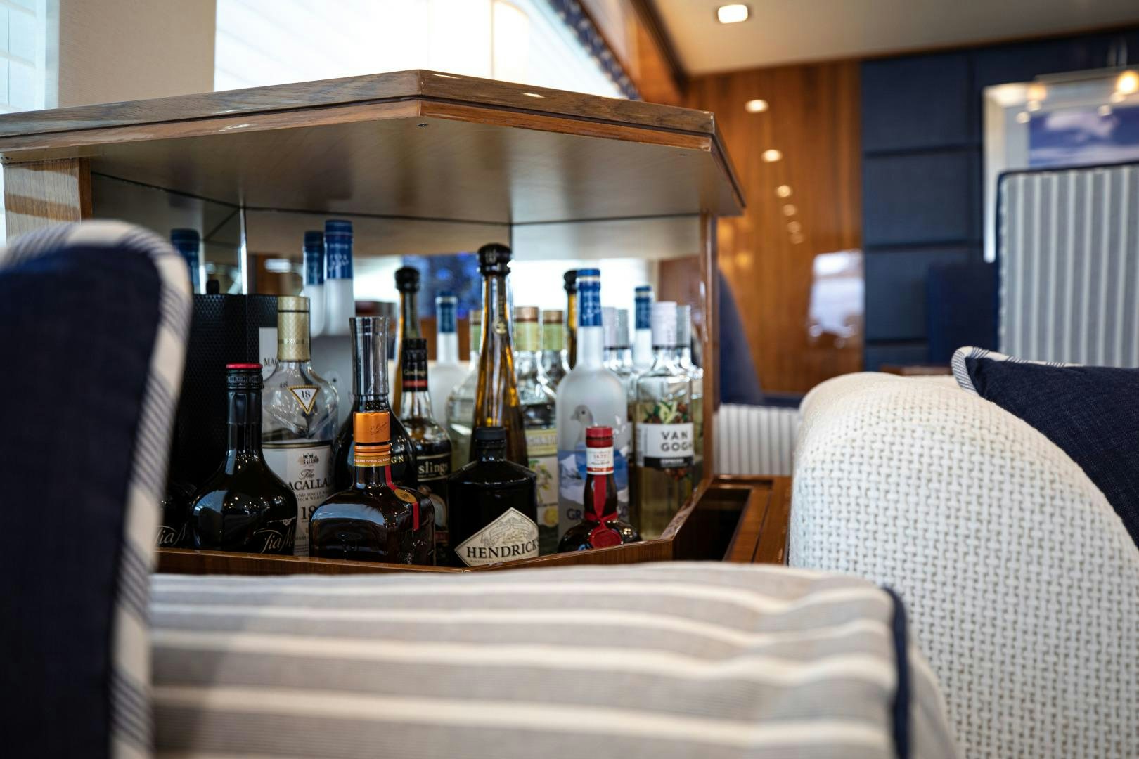 a table with bottles of wine on it aboard INDIGO Yacht for Sale