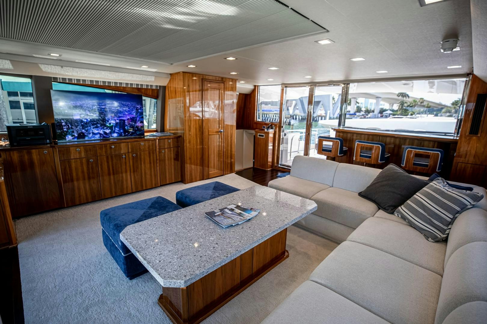 a living room with a table and couches aboard INDIGO Yacht for Sale