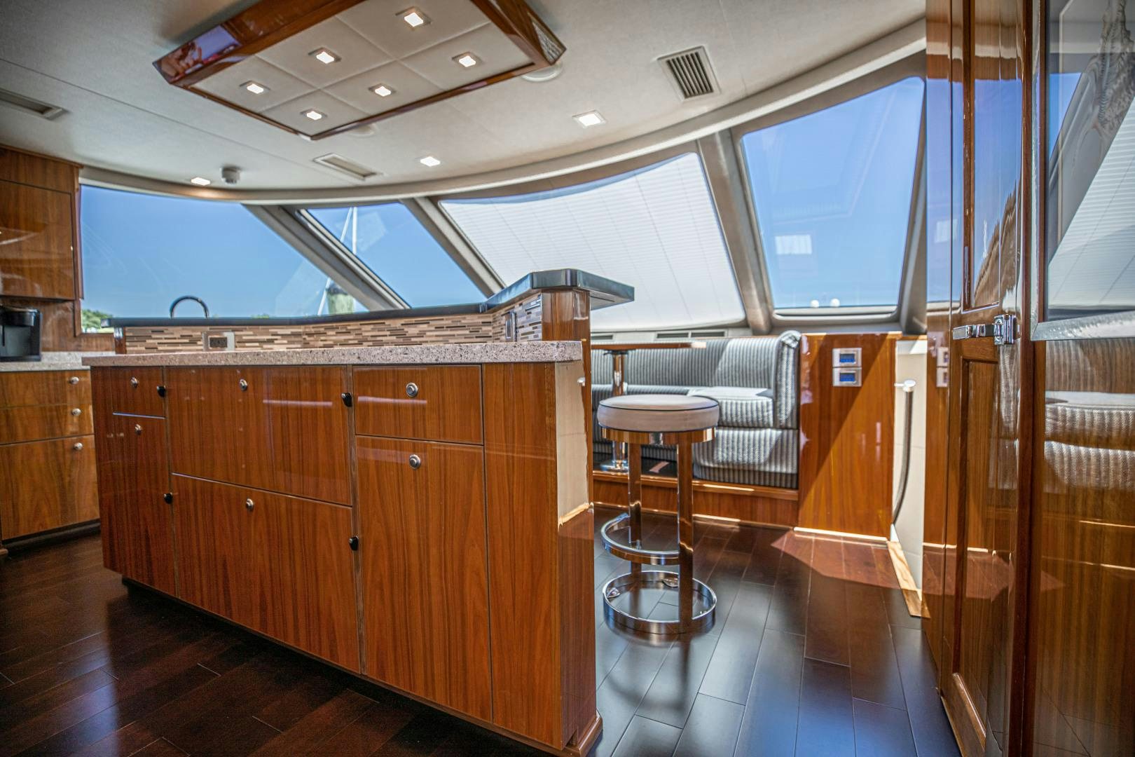 a kitchen with wooden cabinets aboard INDIGO Yacht for Sale