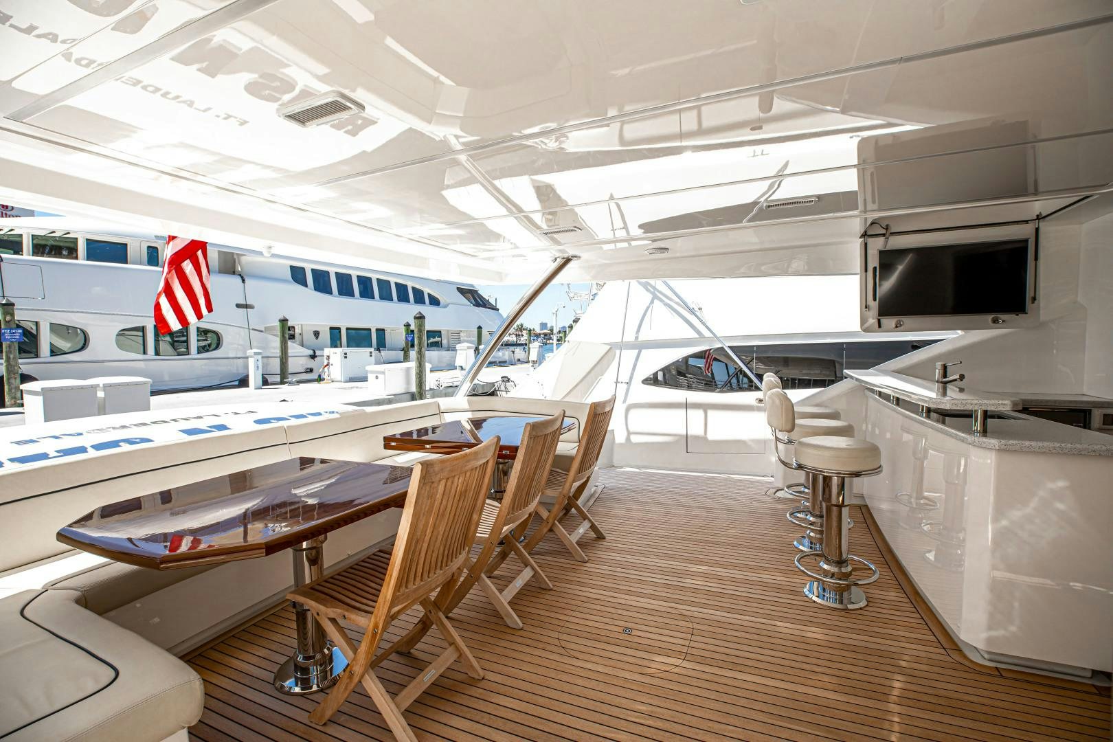 a room with tables and chairs aboard INDIGO Yacht for Sale