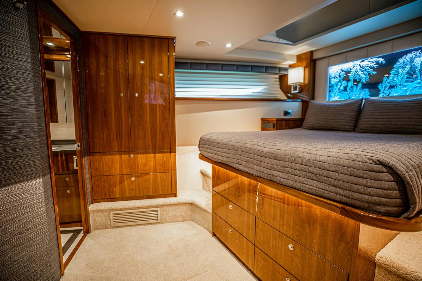 a bedroom with a bed and a closet aboard INDIGO Yacht for Sale
