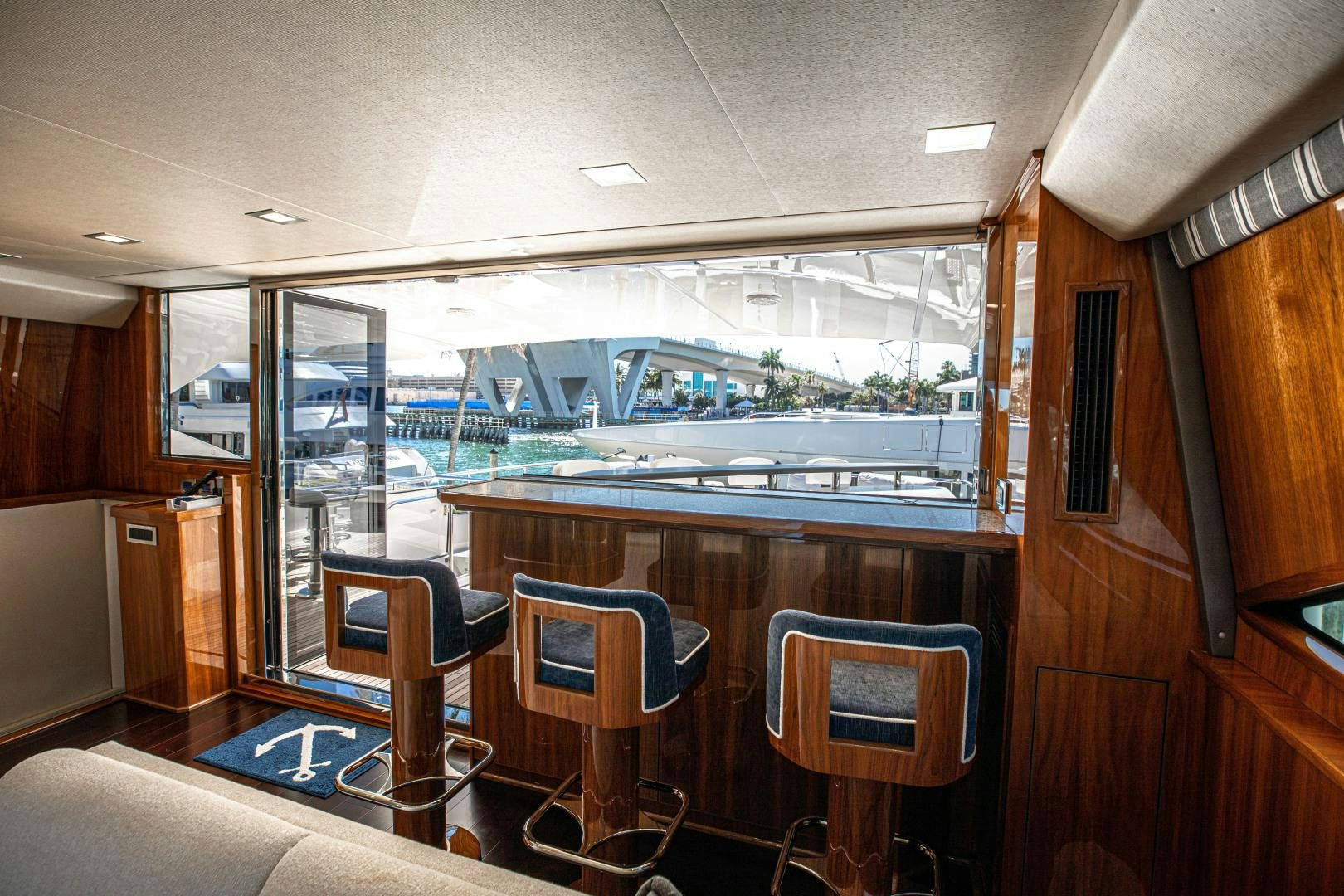 a room with a table chairs and a large window aboard INDIGO Yacht for Sale