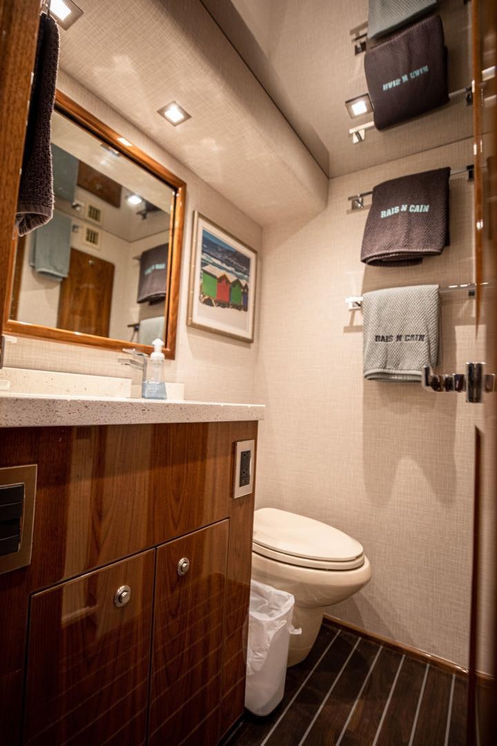 a bathroom with a toilet and a mirror aboard INDIGO Yacht for Sale