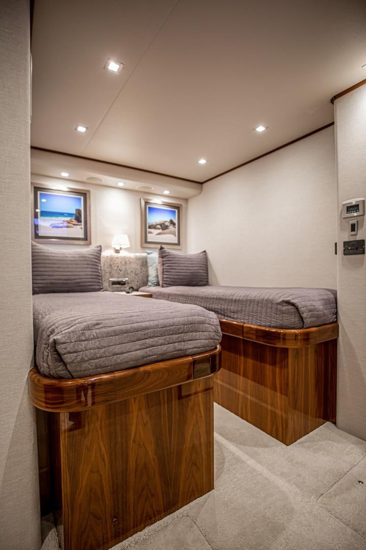 a bedroom with two beds aboard INDIGO Yacht for Sale