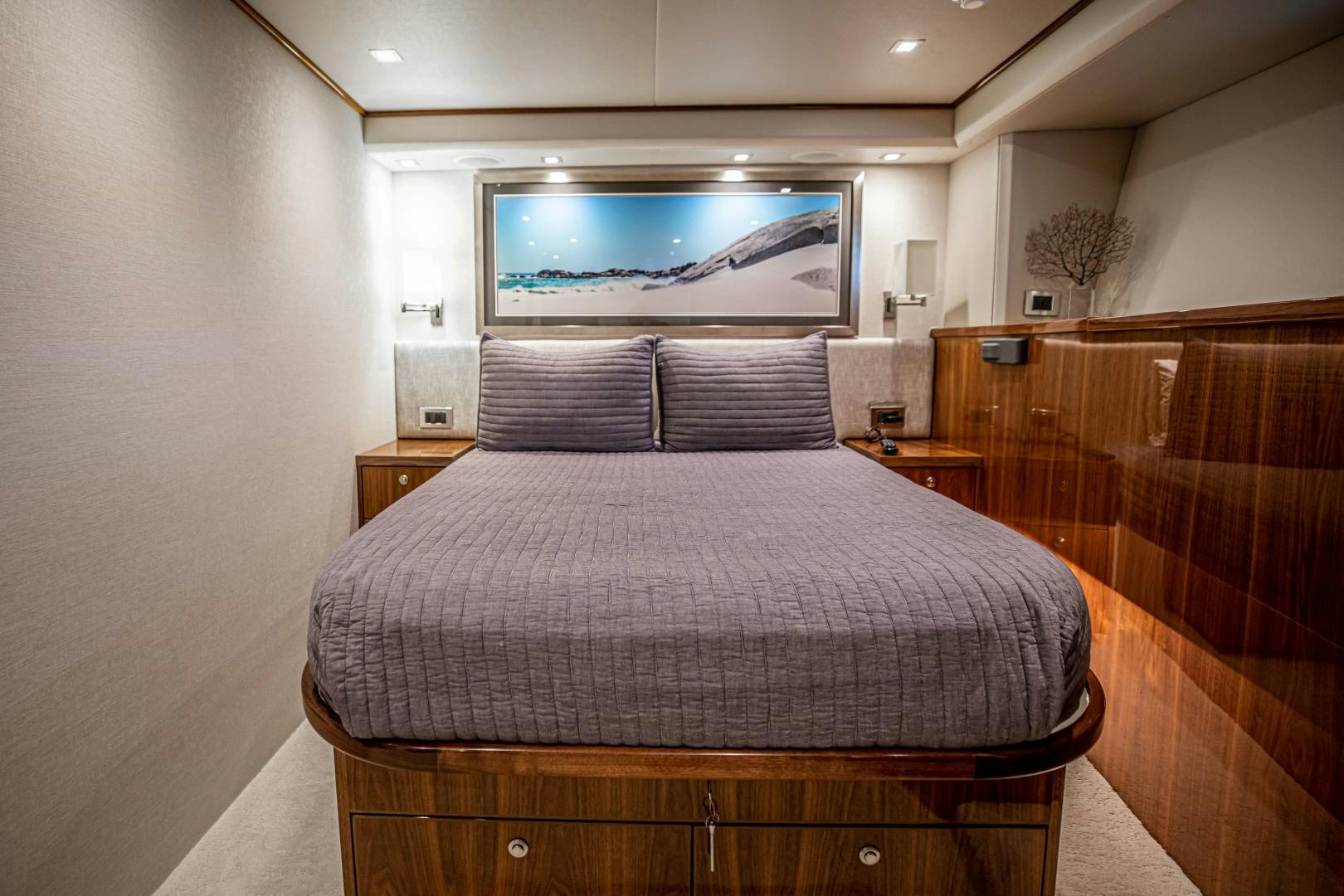 a bed with a television on the wall aboard INDIGO Yacht for Sale