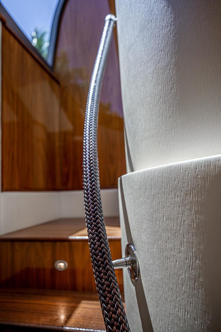 a pair of black and silver striped socks from a white rack aboard INDIGO Yacht for Sale