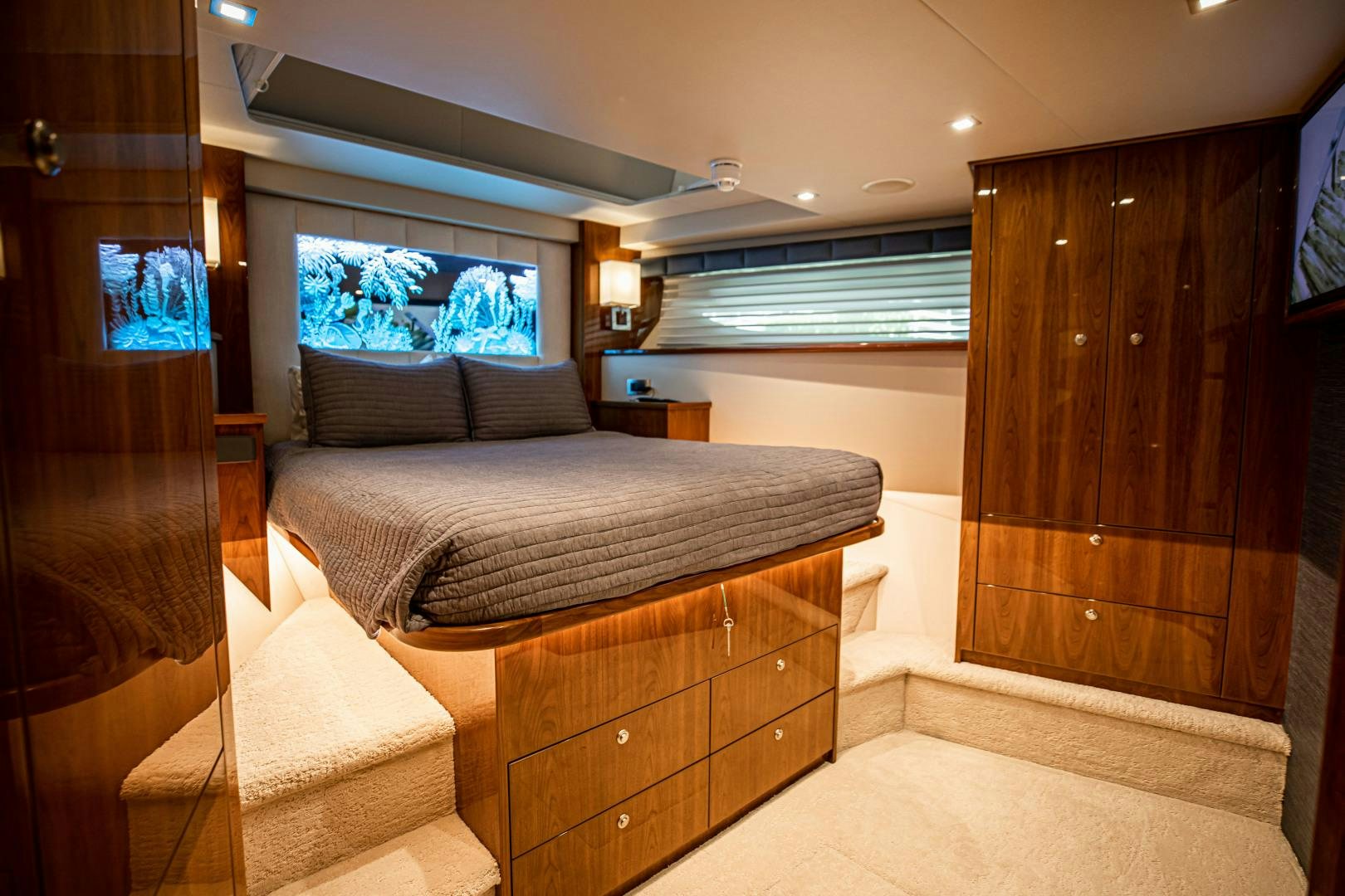 a bedroom with a bed and a dresser aboard INDIGO Yacht for Sale
