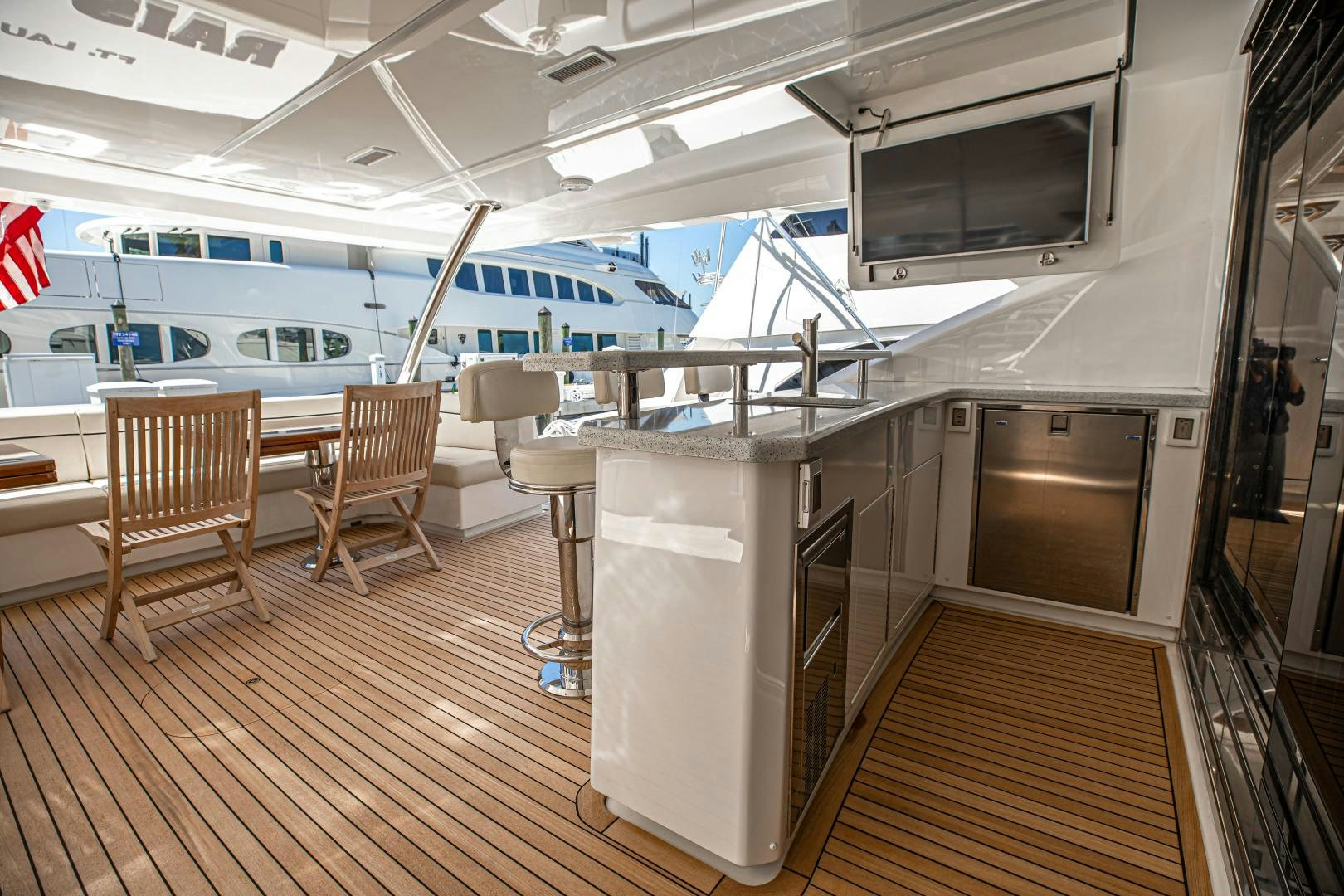 a room with chairs and a television aboard INDIGO Yacht for Sale