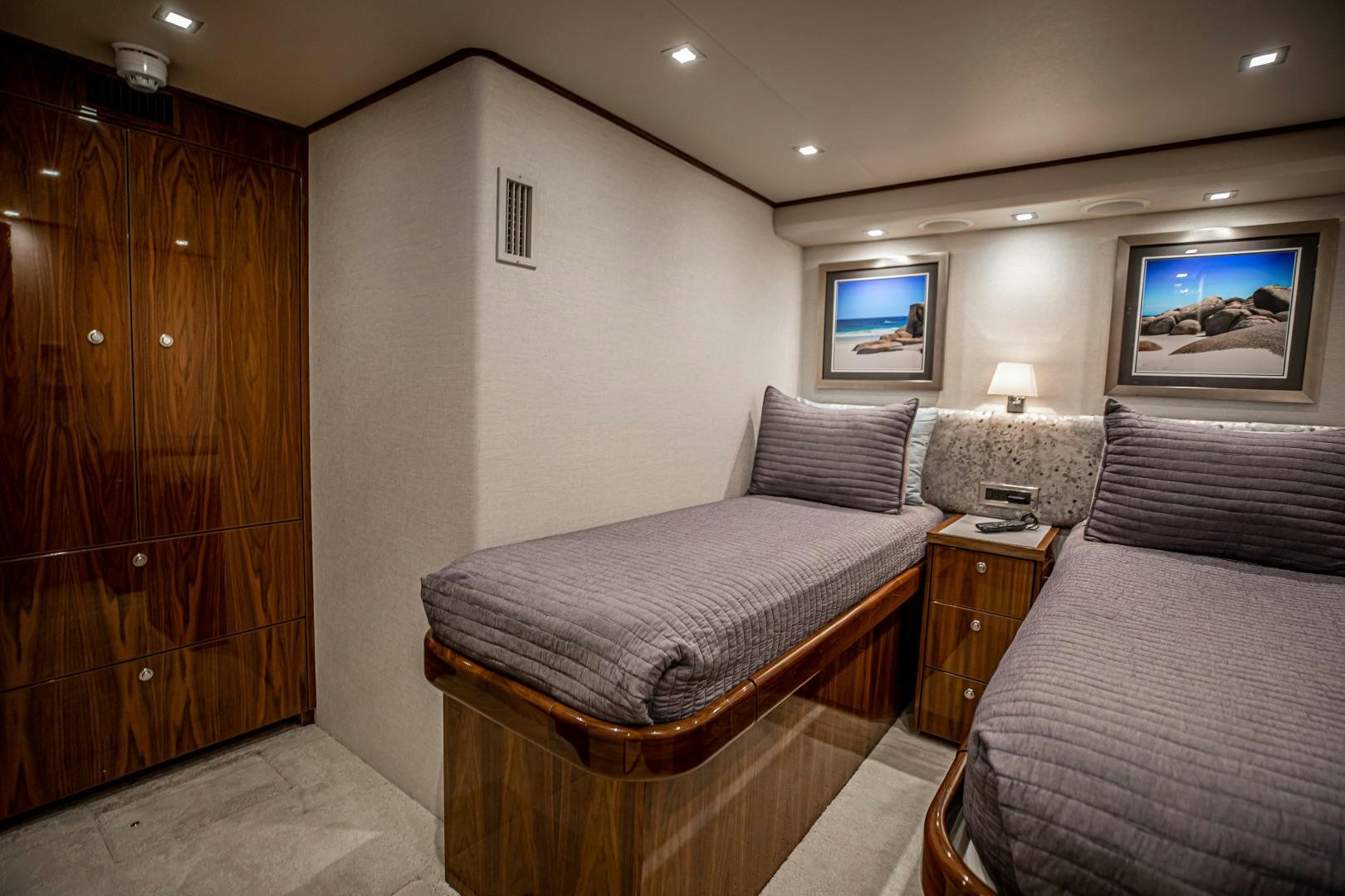a bedroom with two beds aboard INDIGO Yacht for Sale
