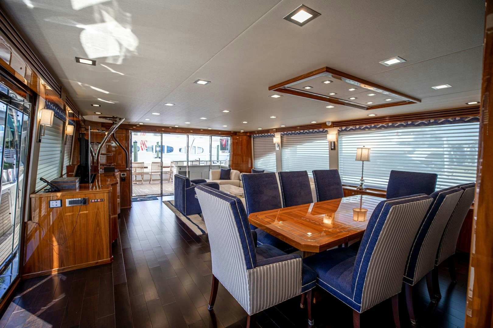 a large room with a table and chairs aboard INDIGO Yacht for Sale