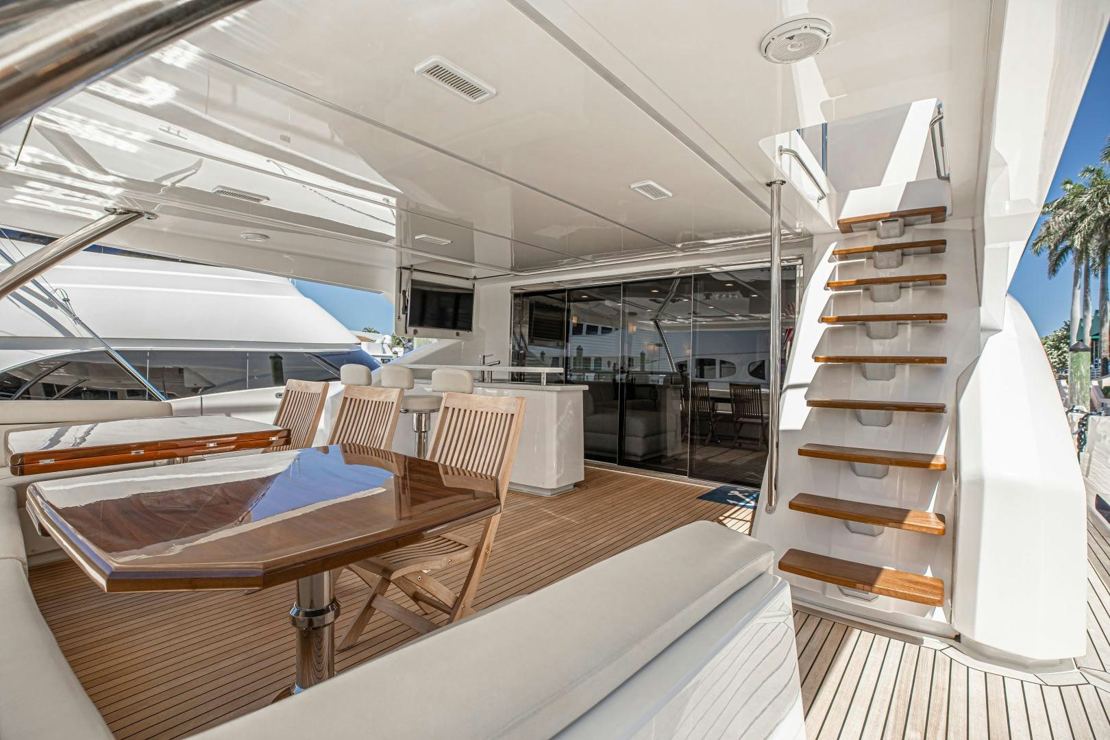 a room with tables and chairs aboard INDIGO Yacht for Sale