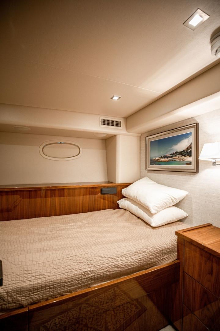 a bed with a white comforter aboard INDIGO Yacht for Sale