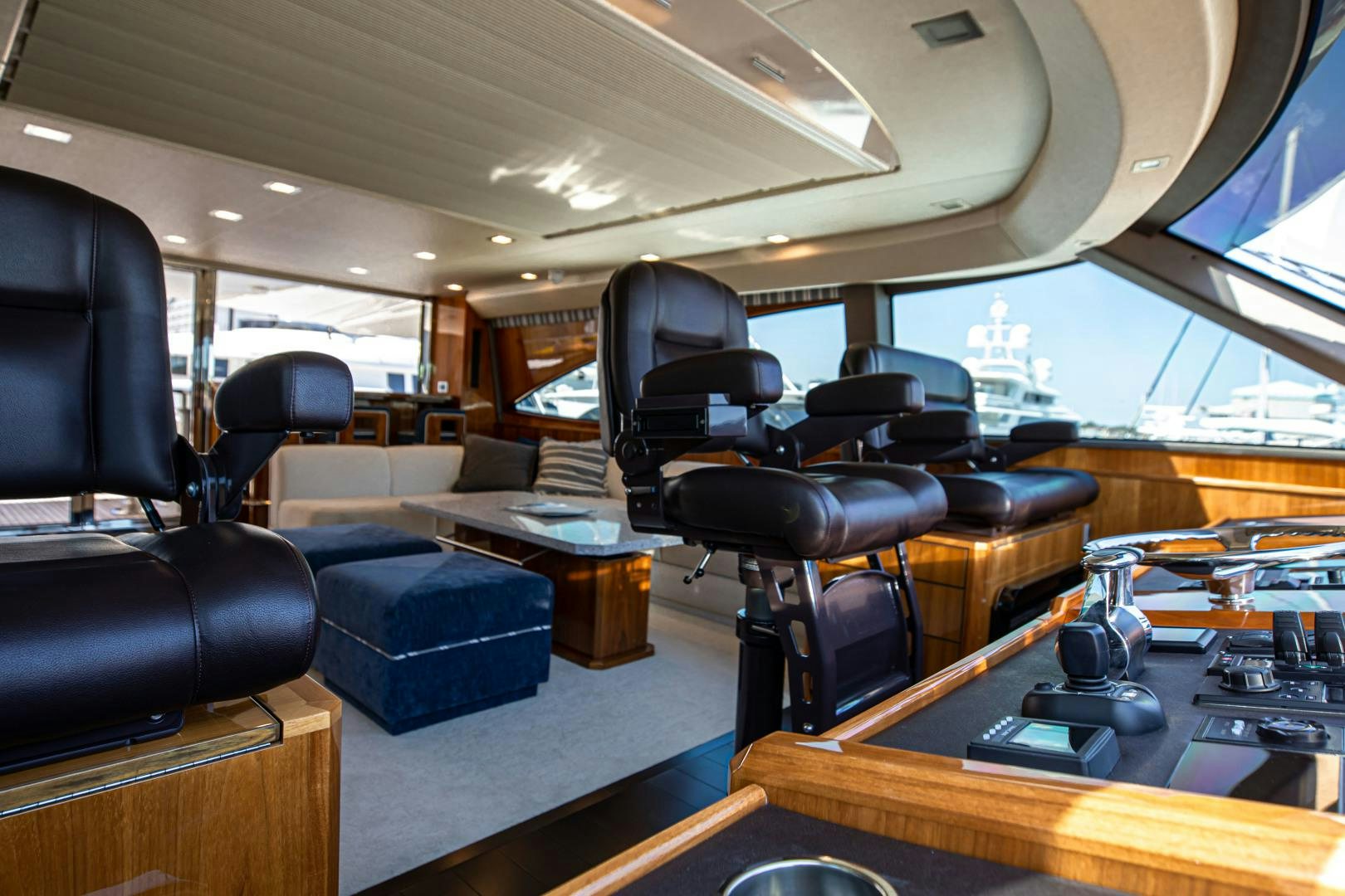 inside of a vehicle with a desk and chairs aboard INDIGO Yacht for Sale