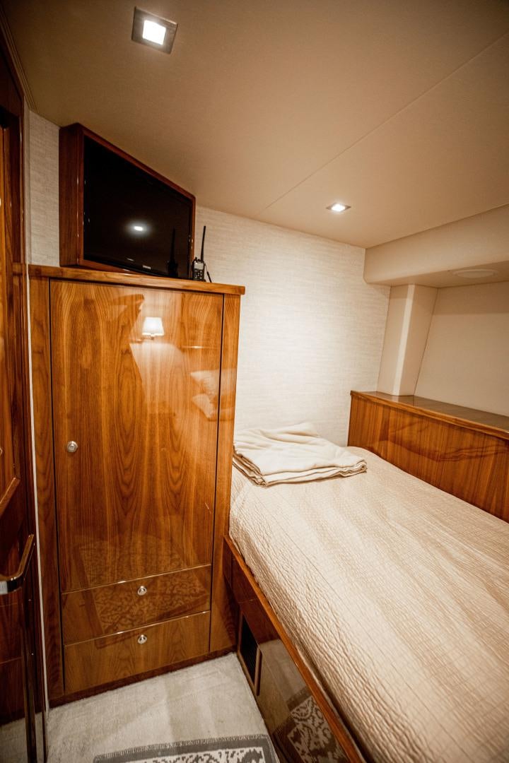 a bedroom with a bed and a television aboard INDIGO Yacht for Sale