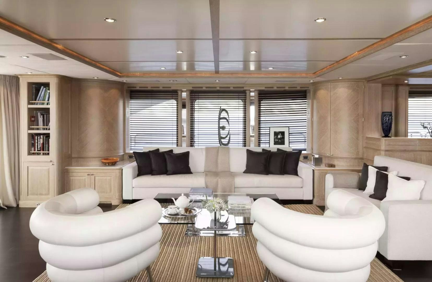 a living room with a couch and a table aboard SOHO Yacht for Sale