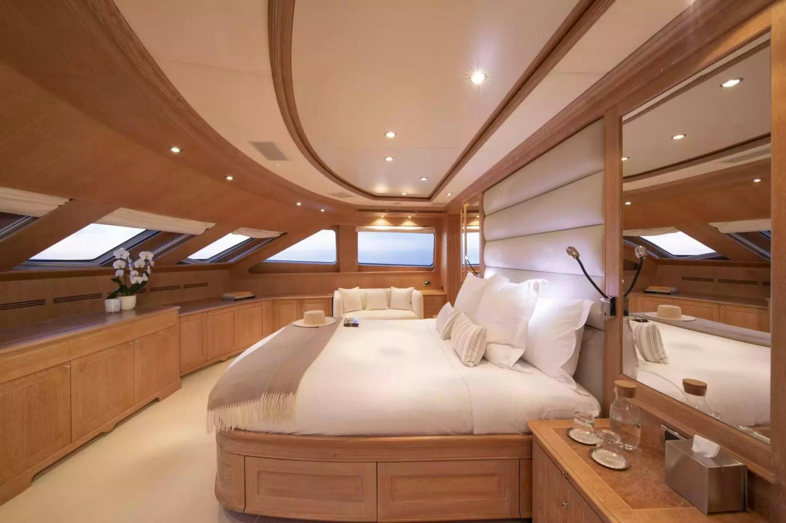 a room with a bed and a table aboard SOHO Yacht for Sale