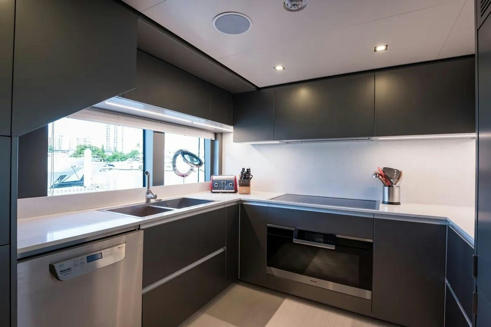 a kitchen with a stove and a sink aboard GIOIA Yacht for Sale