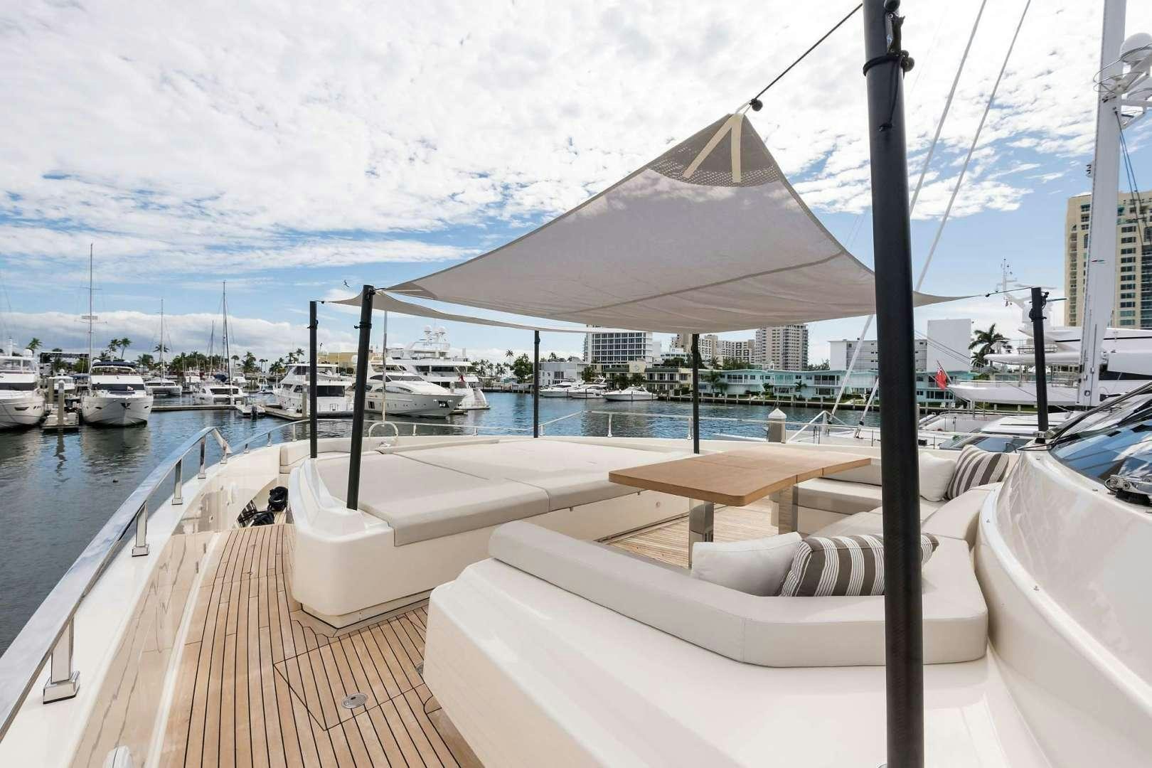 a deck with a covered area and boats in the water aboard GIOIA Yacht for Sale