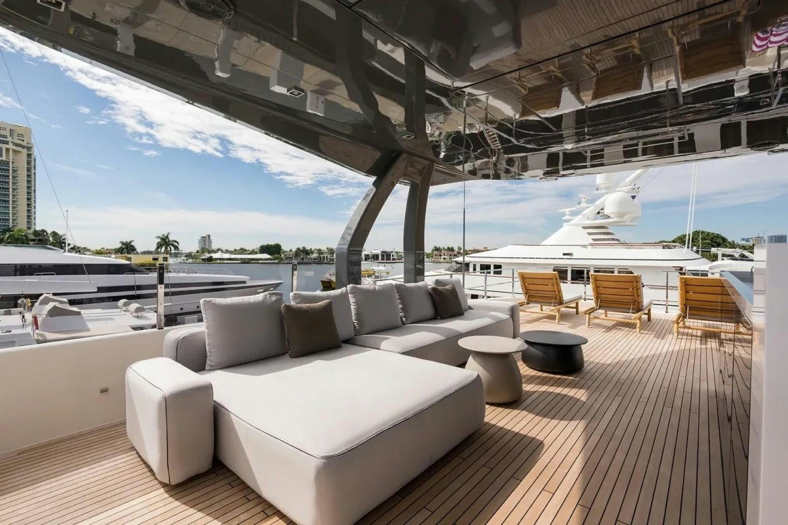 a large lounge area with a large deck and a large body of water aboard GIOIA Yacht for Sale
