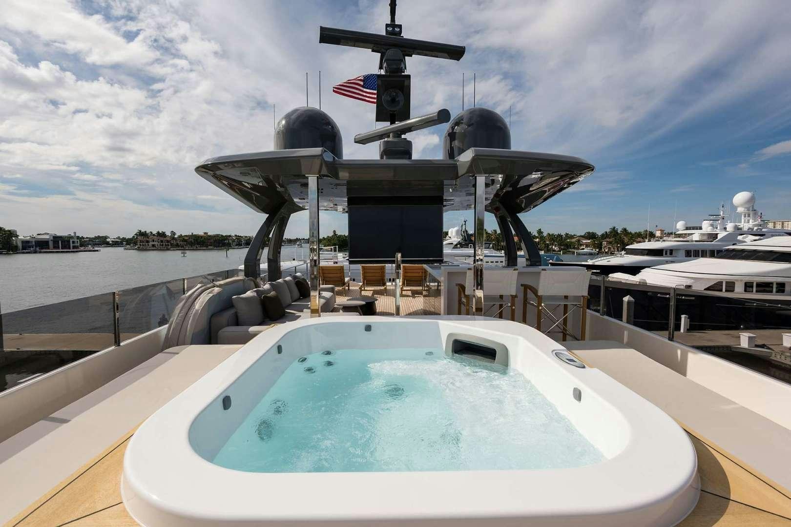 a large white boat with a black and red flag on it aboard GIOIA Yacht for Sale