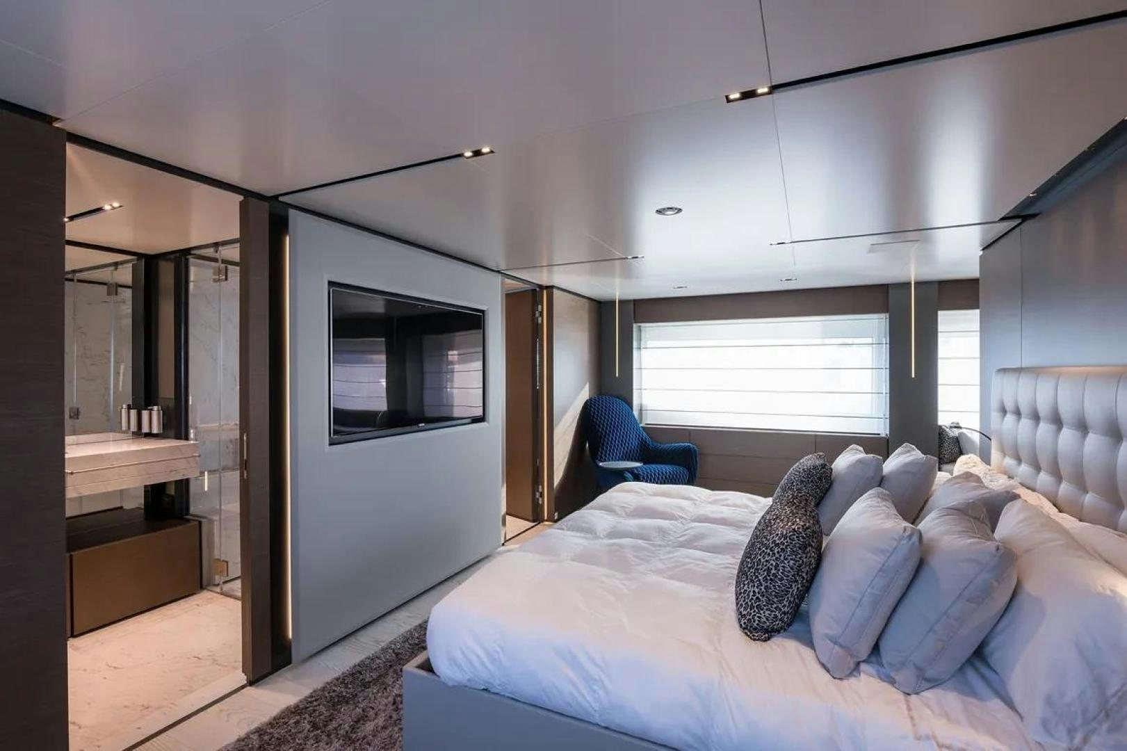 a bedroom with a bed and a chair aboard GIOIA Yacht for Sale