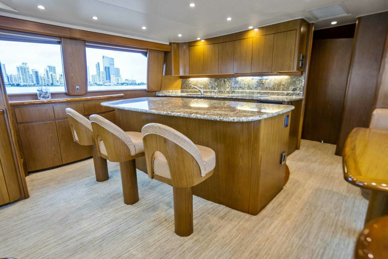 a kitchen with a bar and stools aboard LAST CALL Yacht for Sale