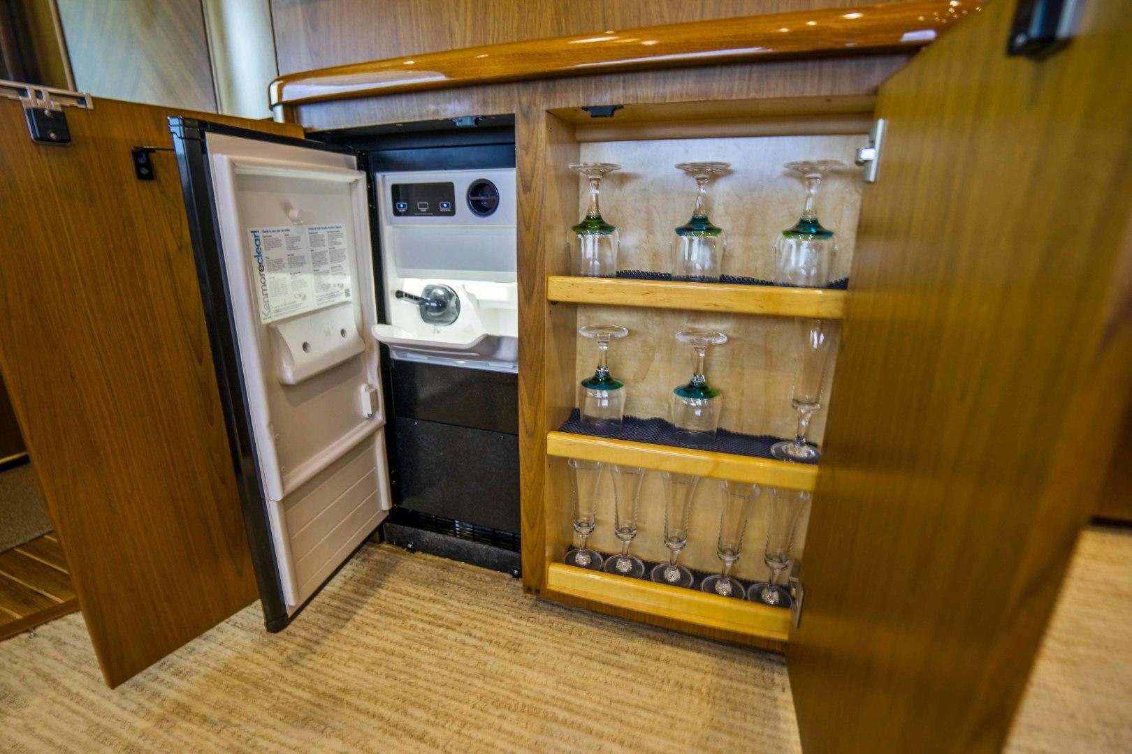 a kitchen with a refrigerator and cabinets aboard LAST CALL Yacht for Sale