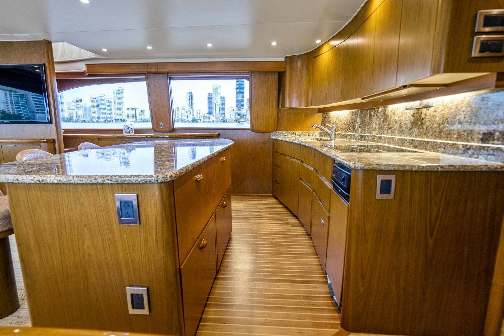 a kitchen with wooden cabinets aboard LAST CALL Yacht for Sale