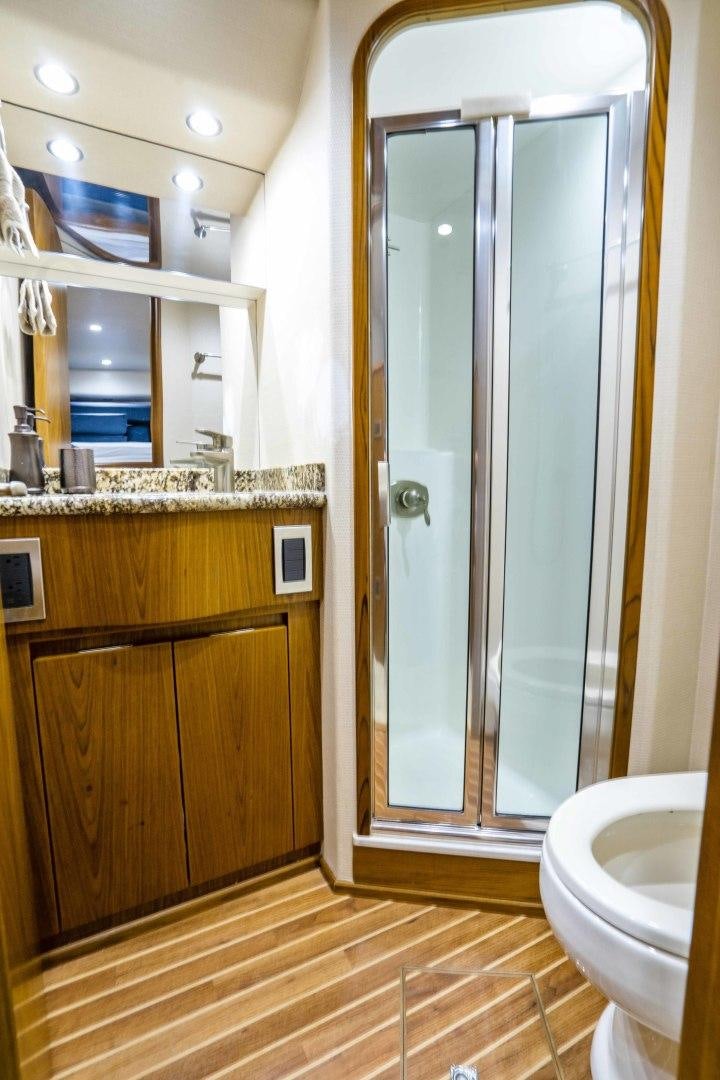 a bathroom with a glass shower door aboard LAST CALL Yacht for Sale