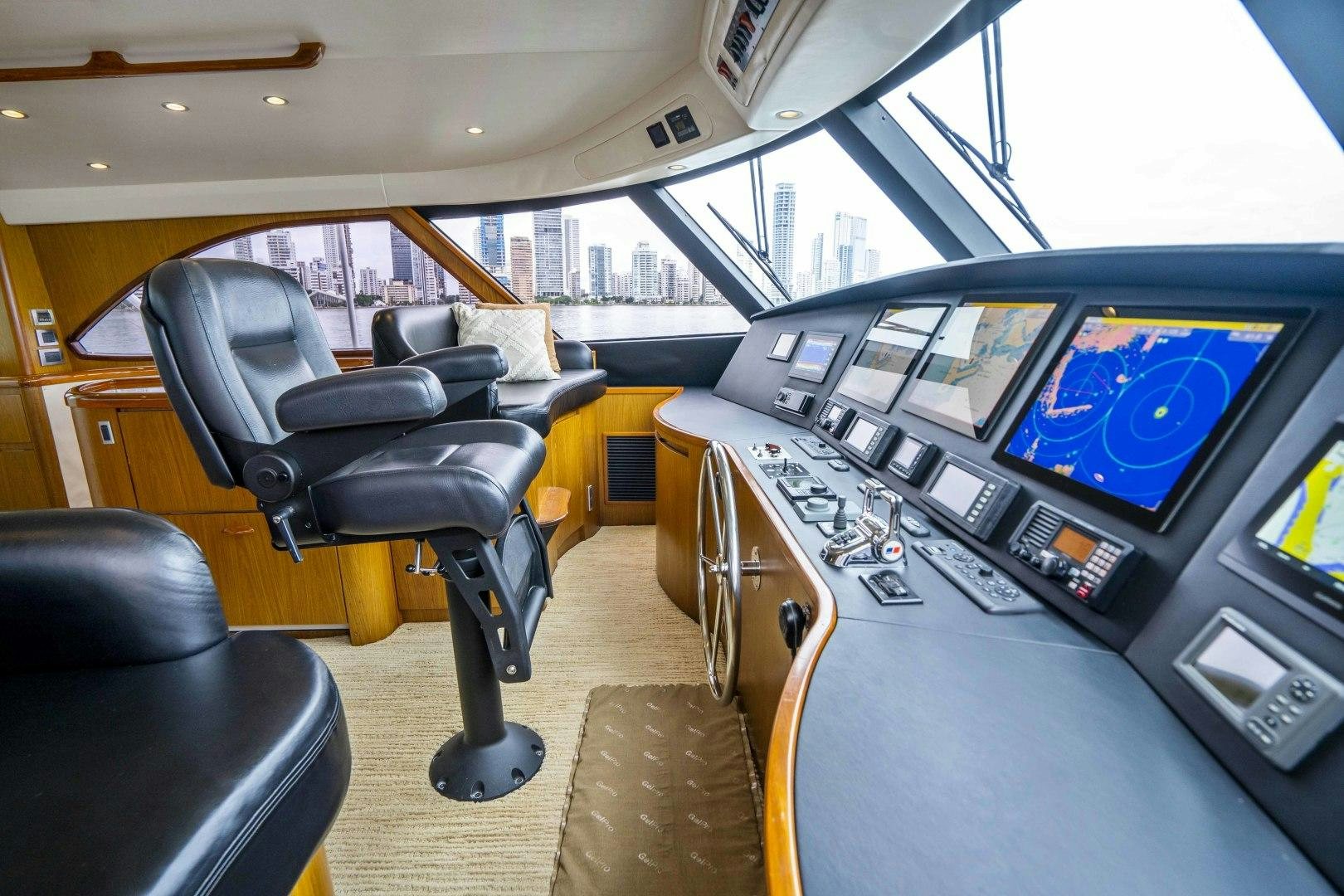inside of a vehicle with a large screen and a black chair aboard LAST CALL Yacht for Sale