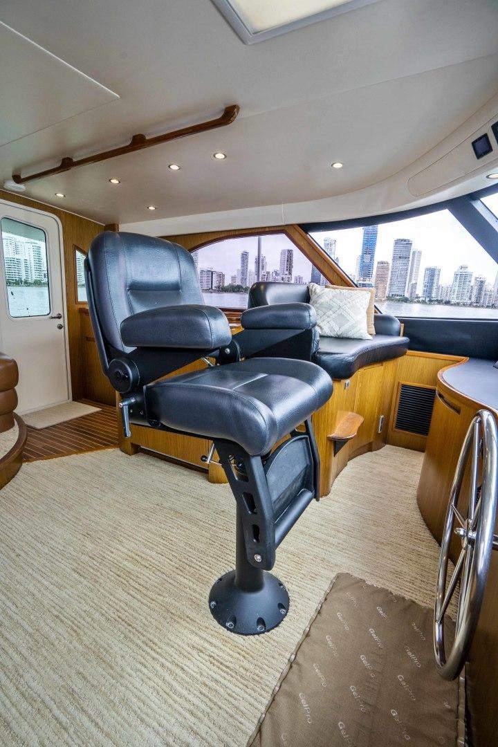 a black leather chair in a room aboard LAST CALL Yacht for Sale