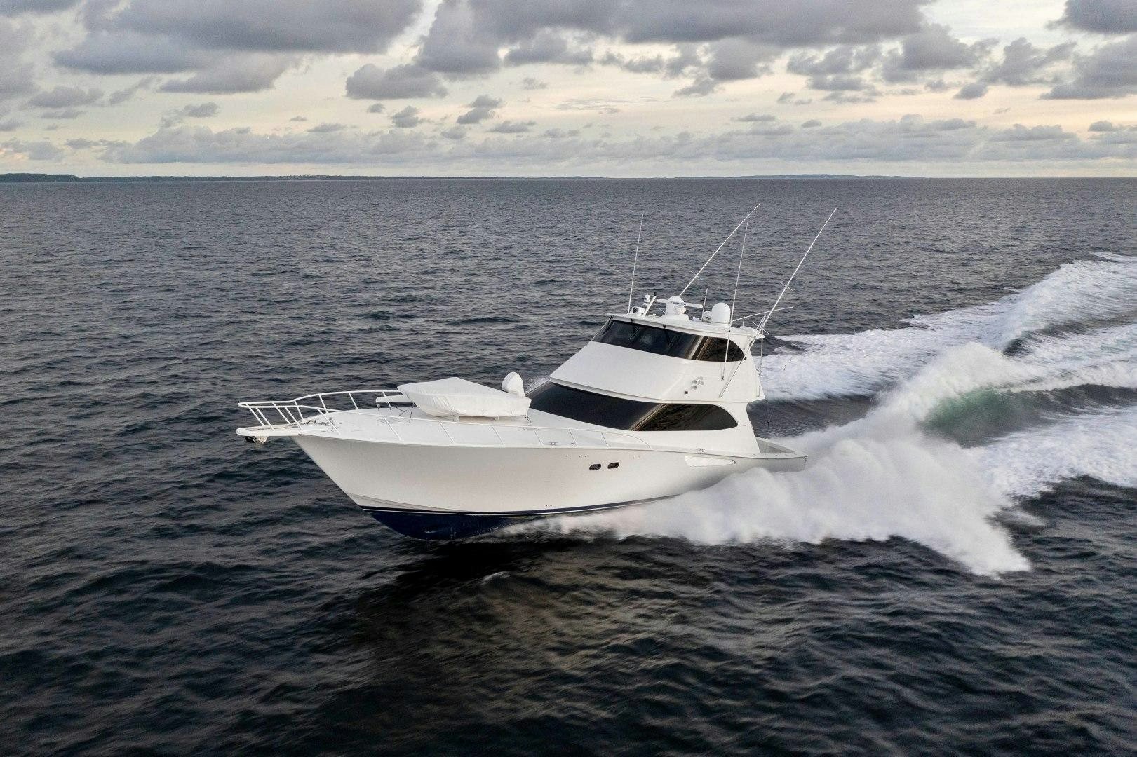 a white boat on the water aboard LAST CALL Yacht for Sale