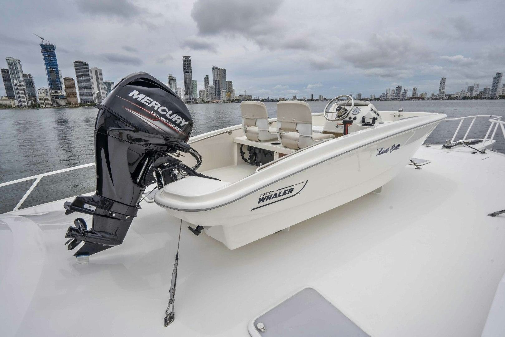 a white speed boat on a body of water aboard LAST CALL Yacht for Sale
