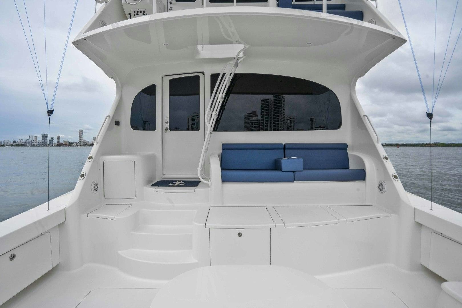 a white boat on a body of water aboard LAST CALL Yacht for Sale