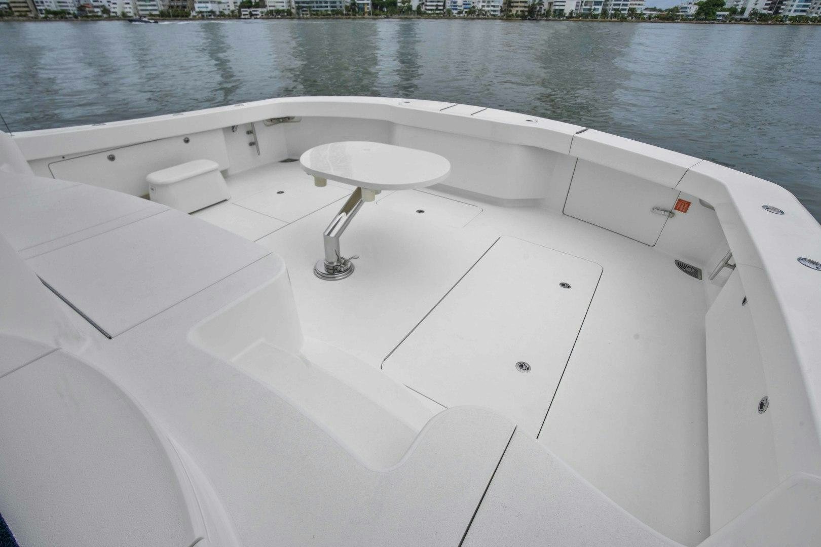 a white boat on a body of water aboard LAST CALL Yacht for Sale