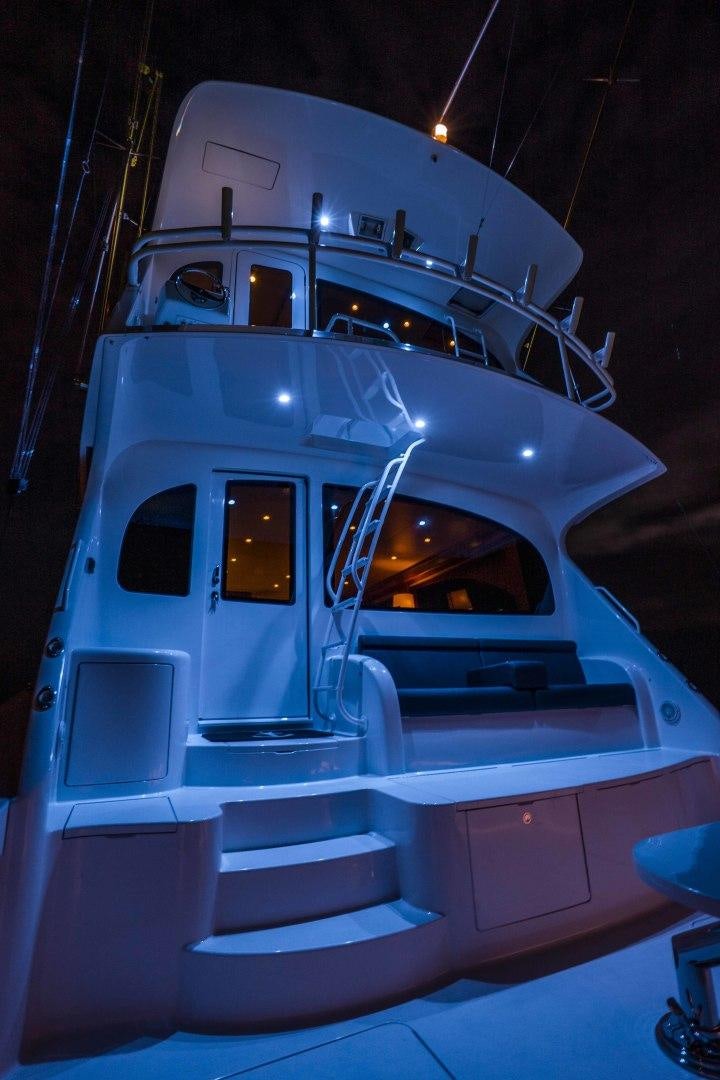 a white boat with a staircase aboard LAST CALL Yacht for Sale