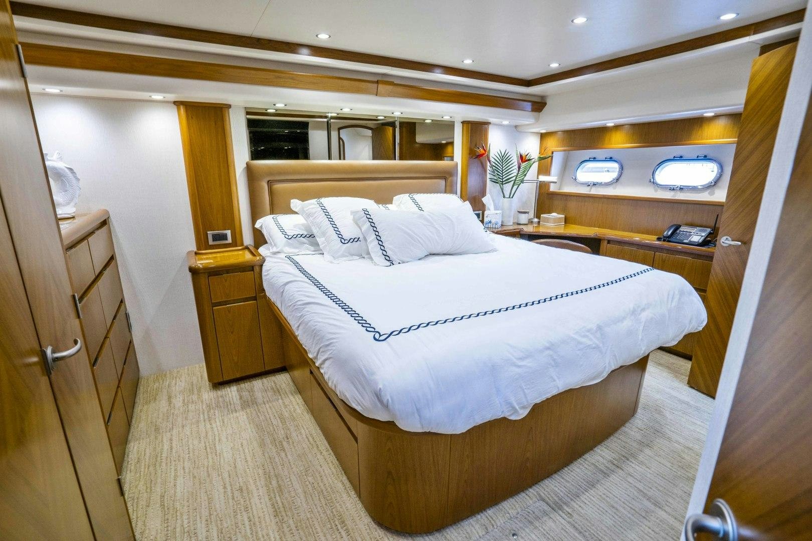 a room with a bed and a desk aboard LAST CALL Yacht for Sale
