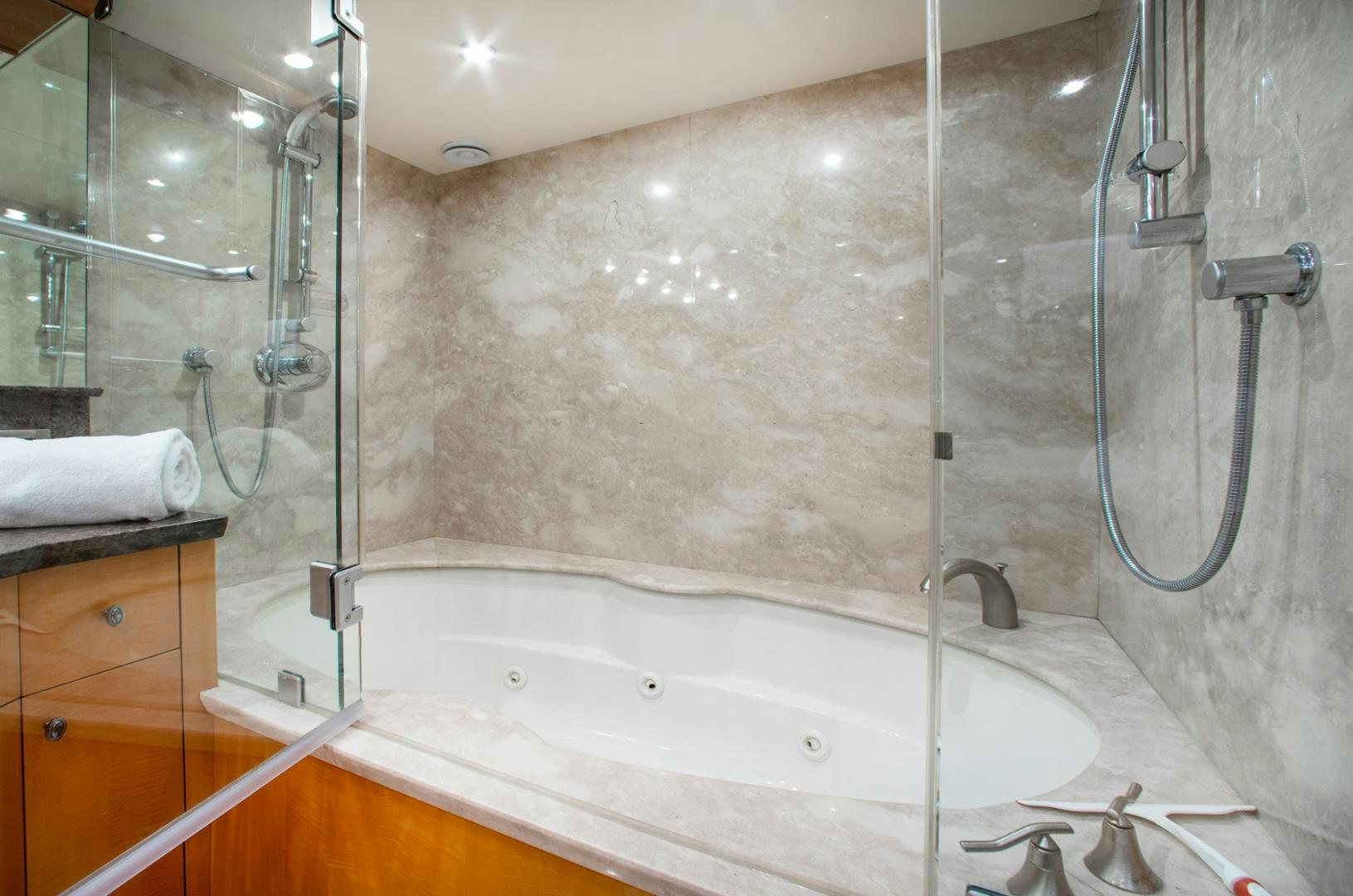 a bathroom with a bathtub and shower aboard 26 NORTH Yacht for Sale