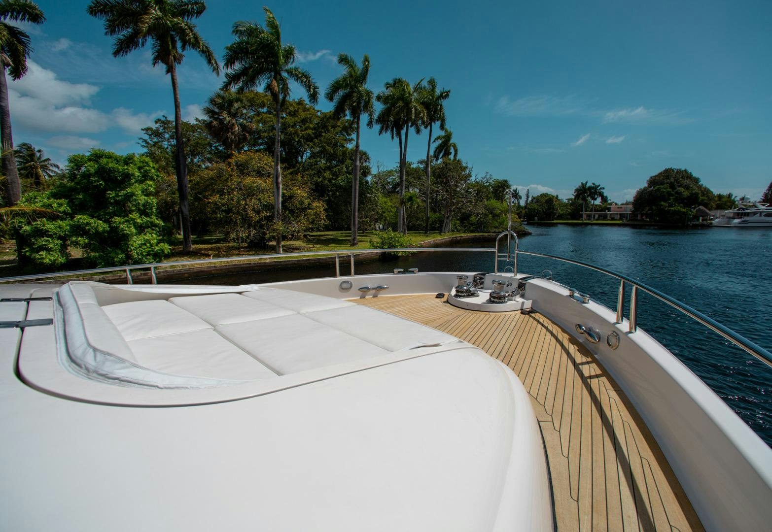 a pool with a boat on it by a beach with palm trees aboard 26 NORTH Yacht for Sale