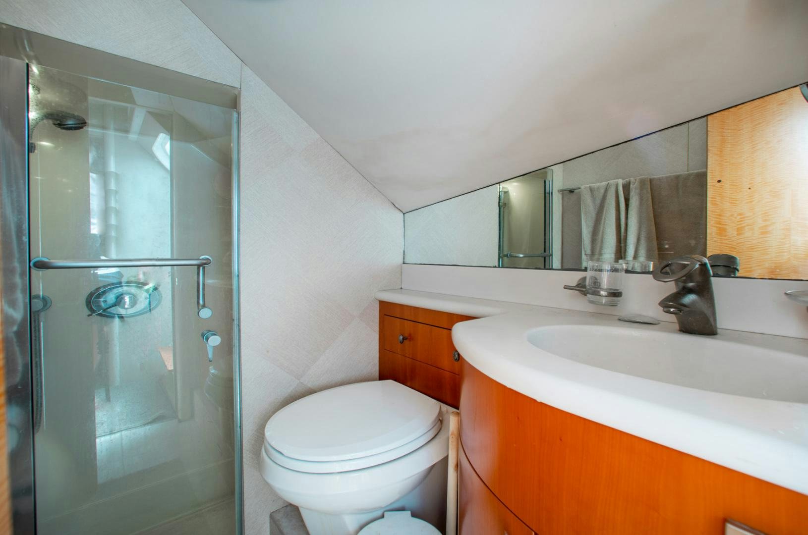 a bathroom with a glass shower aboard 26 NORTH Yacht for Sale