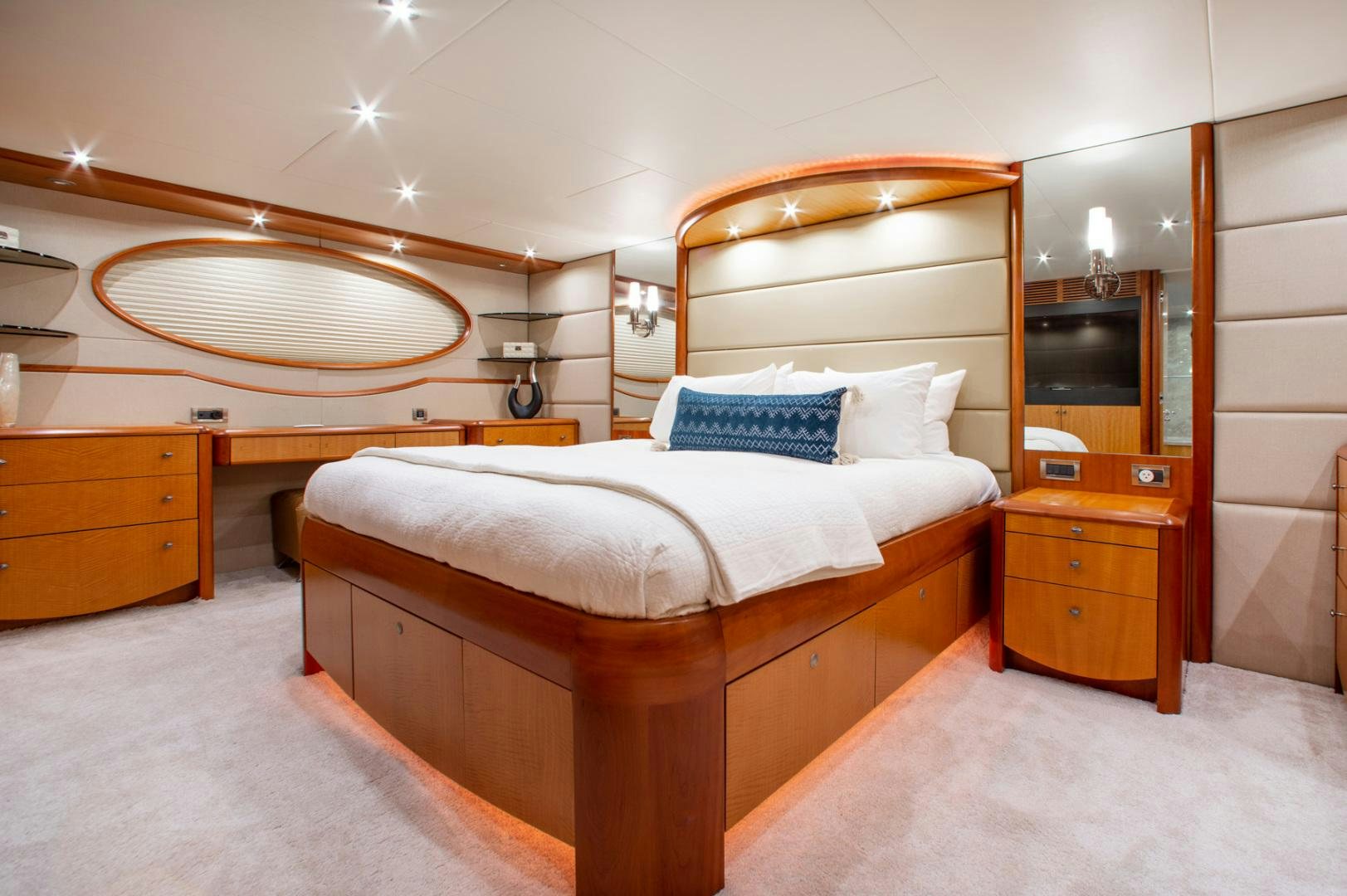 a bedroom with a bed and a dresser aboard 26 NORTH Yacht for Sale